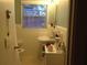 Cozy bathroom with a toilet, sink, white-tiled walls, and a window at 2477 N Decatur Rd # A1, Decatur, GA 30033