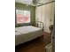 Bright bedroom featuring a ceiling fan, wood floors and a large window for natural light at 2477 N Decatur Rd # A1, Decatur, GA 30033