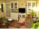 Cozy living room with hardwood floors, couch, entertainment center, and shelving at 2477 N Decatur Rd # A1, Decatur, GA 30033