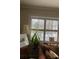 Bright living room featuring a cozy couch and large window with shutters at 2477 N Decatur Rd # A1, Decatur, GA 30033