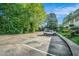 Parking lot view with greenery and the side of the building in the distance at 2477 N Decatur Rd # A1, Decatur, GA 30033