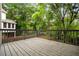 A spacious wood deck overlooks a lush, green backyard and treeline providing backyard privacy at 7035 Hampton Bluff Way, Roswell, GA 30075