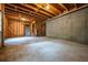 Spacious unfinished basement ready to be transformed with exposed beams and concrete walls at 7035 Hampton Bluff Way, Roswell, GA 30075