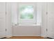 A bright bathroom featuring a large soaking tub beneath a window at 7035 Hampton Bluff Way, Roswell, GA 30075
