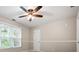 Bedroom featuring a ceiling fan, a window and neutral paint at 7035 Hampton Bluff Way, Roswell, GA 30075