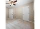 Bright bedroom features a ceiling fan, neutral walls and carpeting, and white doors at 7035 Hampton Bluff Way, Roswell, GA 30075