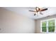Bright bedroom with a ceiling fan and a window with blinds at 7035 Hampton Bluff Way, Roswell, GA 30075