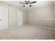 Spacious bedroom with neutral carpet and paint and two entry doors at 7035 Hampton Bluff Way, Roswell, GA 30075