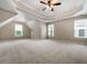 Bonus room featuring a tray ceiling, carpeting, and many windows for plenty of natural light at 7035 Hampton Bluff Way, Roswell, GA 30075