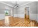 Spacious dining room with hardwood floors, crown molding, and natural light flowing through large windows at 7035 Hampton Bluff Way, Roswell, GA 30075