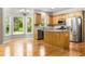 Bright eat-in kitchen with stainless steel appliances, granite counters, a kitchen island, and many windows overlooking green space at 7035 Hampton Bluff Way, Roswell, GA 30075