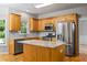 Eat-in kitchen with granite counters, tile backsplash, stainless appliances, and an island for food preparation and entertaining at 7035 Hampton Bluff Way, Roswell, GA 30075