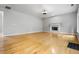 Spacious living room featuring a decorative fireplace, hardwood floors, neutral walls, and abundant natural light at 7035 Hampton Bluff Way, Roswell, GA 30075