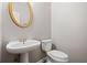 Modern powder room with a vessel sink, brushed nickel fixtures, and decorative oval mirror at 7035 Hampton Bluff Way, Roswell, GA 30075