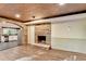 Finished basement with a stone fireplace, full kitchen view, and wood-look flooring at 975 Timber Lake Trl, Cumming, GA 30041