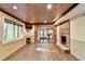 Basement space with stone fireplace, wood floor, textured ceiling, and large window at 975 Timber Lake Trl, Cumming, GA 30041