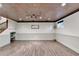 Large finished basement with decorative ceiling, recessed lighting and staircase at 975 Timber Lake Trl, Cumming, GA 30041