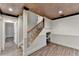 Finished basement with wood-look floors, decorative ceiling and staircase at 975 Timber Lake Trl, Cumming, GA 30041