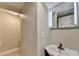 Small, simple bathroom features vanity mirror with light fixture and sink at 975 Timber Lake Trl, Cumming, GA 30041