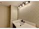 Charming bathroom features a sleek vanity, modern lighting, and stylish patterned wallpaper at 975 Timber Lake Trl, Cumming, GA 30041