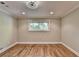 Inviting bedroom featuring hardwood floors and natural light from a window at 975 Timber Lake Trl, Cumming, GA 30041