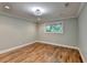 Neutral bedroom features hardwood flooring, recessed lighting, and view of outdoors at 975 Timber Lake Trl, Cumming, GA 30041