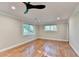 Airy bedroom with hardwood floors, recessed lighting, and windows overlooking greenery at 975 Timber Lake Trl, Cumming, GA 30041