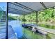 Boat slip with metal awning and ladder on a calm lake surrounded by lush greenery at 975 Timber Lake Trl, Cumming, GA 30041
