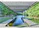 View from inside the covered boat slip onto the glistening water of the lake at 975 Timber Lake Trl, Cumming, GA 30041
