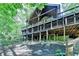 Spacious home exterior featuring a multi-level deck with natural wood and beautiful surroundings with lush greenery at 975 Timber Lake Trl, Cumming, GA 30041