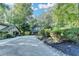 Beautiful home exterior featuring a long driveway and mature trees, offering privacy at 975 Timber Lake Trl, Cumming, GA 30041