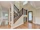 Elegant foyer with hardwood floors, staircase with iron railings, and natural light at 975 Timber Lake Trl, Cumming, GA 30041