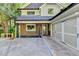 Detached garage with stone accents and a unique design, complemented by lush greenery at 975 Timber Lake Trl, Cumming, GA 30041