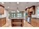Gourmet kitchen featuring a center island with granite countertop and stainless steel appliances at 975 Timber Lake Trl, Cumming, GA 30041