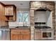 Kitchen with stainless steel appliances and brick oven surround at 975 Timber Lake Trl, Cumming, GA 30041
