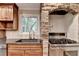 Kitchen with stainless steel appliances and brick oven surround at 975 Timber Lake Trl, Cumming, GA 30041