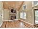 Living room featuring a stone fireplace, wood-paneled ceiling, and hardwood floors at 975 Timber Lake Trl, Cumming, GA 30041