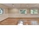 Bright and airy living room featuring hardwood floors, wainscoting, and large windows at 975 Timber Lake Trl, Cumming, GA 30041