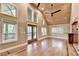 Open living area with wood-paneled ceiling, hardwood floors, and access to the deck at 975 Timber Lake Trl, Cumming, GA 30041