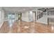 Spacious living room featuring hardwood floors, white trim, and a staircase with iron railings at 975 Timber Lake Trl, Cumming, GA 30041