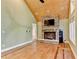 Living room featuring a stone fireplace, wood-paneled ceiling, and hardwood floors at 975 Timber Lake Trl, Cumming, GA 30041