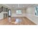 Bright living room with hardwood floors, wainscoting, and a large window at 975 Timber Lake Trl, Cumming, GA 30041