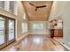 Living room with wood-paneled ceiling, hardwood floors, and an open floor plan at 975 Timber Lake Trl, Cumming, GA 30041