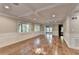 Spacious living room with hardwood floors, beamed ceilings, and ample natural light at 975 Timber Lake Trl, Cumming, GA 30041