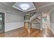 Bright living room featuring hardwood floors, staircase, and wainscotting at 975 Timber Lake Trl, Cumming, GA 30041