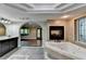 Large bath featuring double sink vanity, tiled floors, walk-through archways, fireplace and jacuzzi at 975 Timber Lake Trl, Cumming, GA 30041