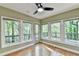 Sunroom with plenty of natural light, a ceiling fan, and access to a deck at 975 Timber Lake Trl, Cumming, GA 30041