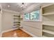Walk-in closet with built-in shelving and a large window for natural light at 975 Timber Lake Trl, Cumming, GA 30041