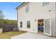 Back of house featuring a small patio, wooden fence, and open door to the interior at 1337 Magnolia Bend Way # 289, Jonesboro, GA 30238