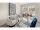 Modern home office with a glass desk, neutral walls, two cozy chairs, and elegant decor providing a serene workspace at 1337 Magnolia Bend Way # 289, Jonesboro, GA 30238